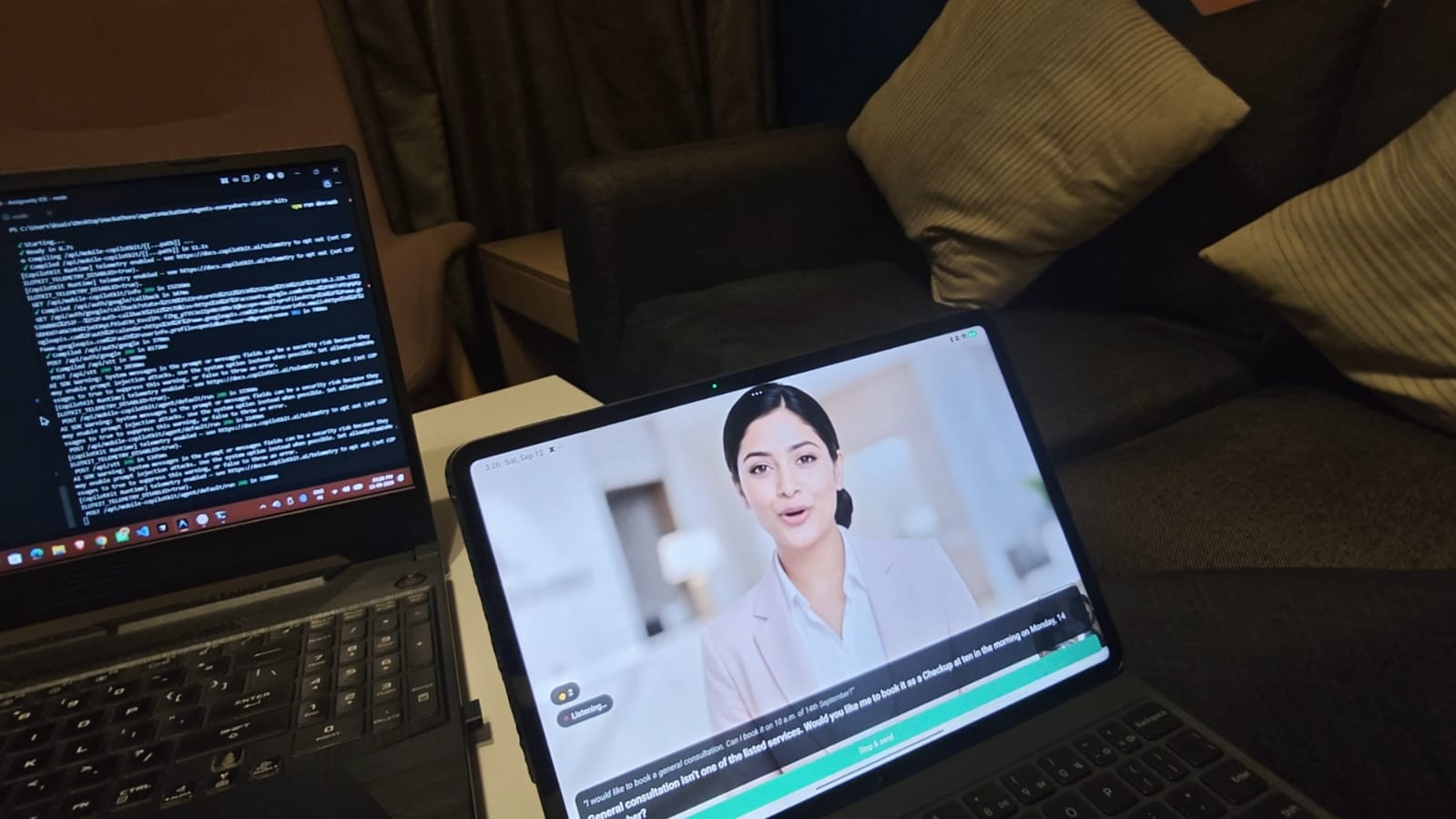 A tablet propped on a table showing the Resse.ai receptionist: a video avatar mid-sentence, a Listening badge, and captions of the conversation. A laptop running the backend sits beside it.