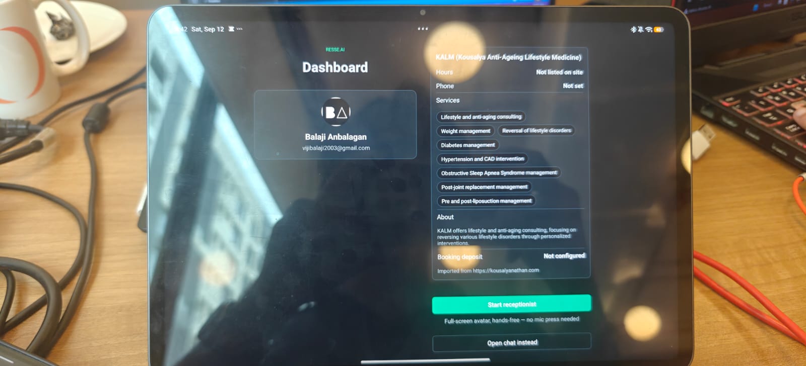 The owner dashboard on a tablet, showing a clinic's hours, services as chips, description, and booking deposit, imported from the clinic's website.